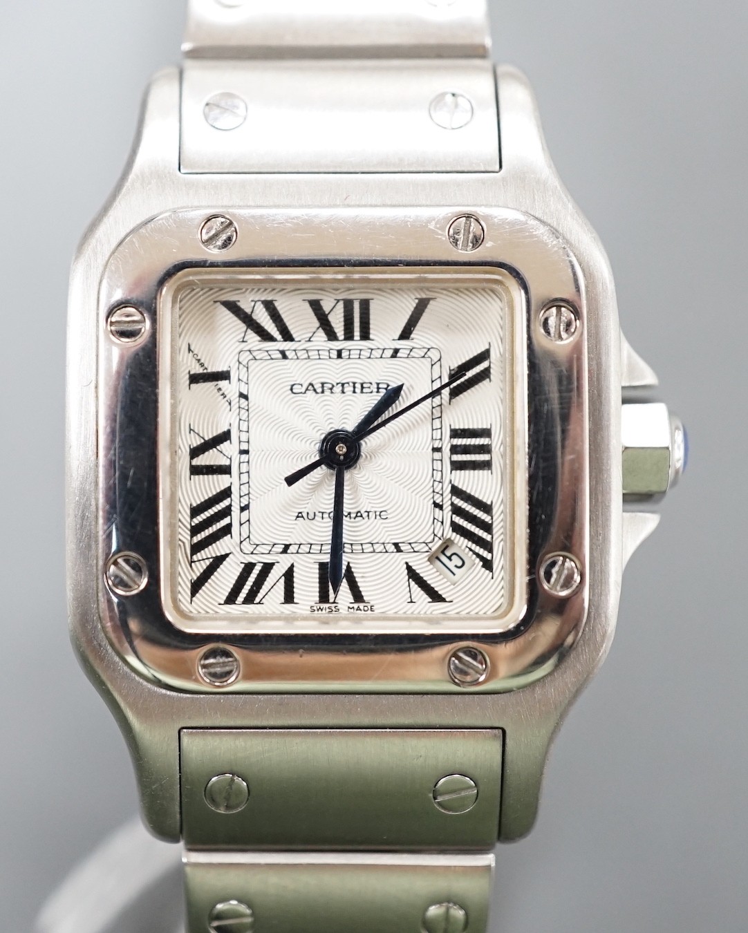 A lady's stainless steel Cartier Santos Automatic wrist watch, on stainless steel Cartier bracelet, with Roman dial and date aperture, no box or papers.